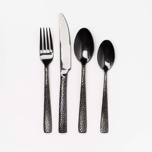 Black stainless flatware set of four on a white background