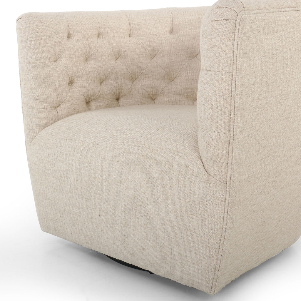 Close up of Barrel style 'Hanover' swivel chair upholstered in cream fabric by Four Hands furniture on a white background 