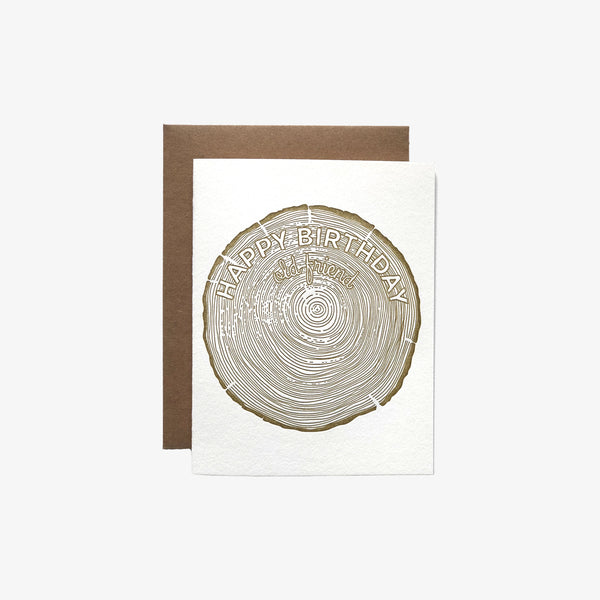 White letter press greeting card with rings of tree and saying 'Happy Birthday Old Friend'