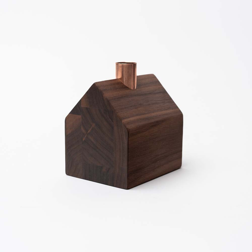 Hauskaa brand wood house candle holder in colonial style with copper chimney on a white background with greenery