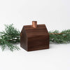 Hauskaa brand wood house candle holder in colonial style with copper chimney on a white background with greenery