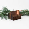 Hauskaa brand wood farmhouse with copper chimney on a white background with greenery 
