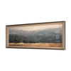 Framed landscape print of a field with trees and mountains behind on a white backrgound