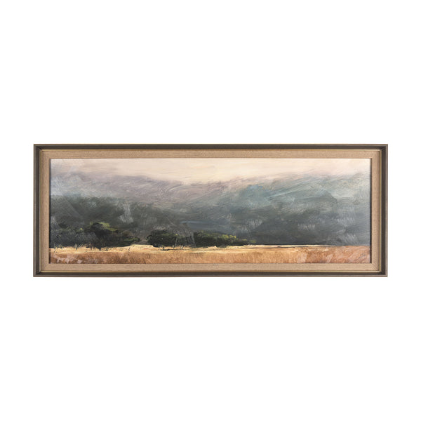 Framed landscape print of a field with trees and mountains behind on a white backrgound
