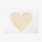 White bathmat with natural heart on a white background