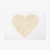 White bathmat with natural heart on a white background