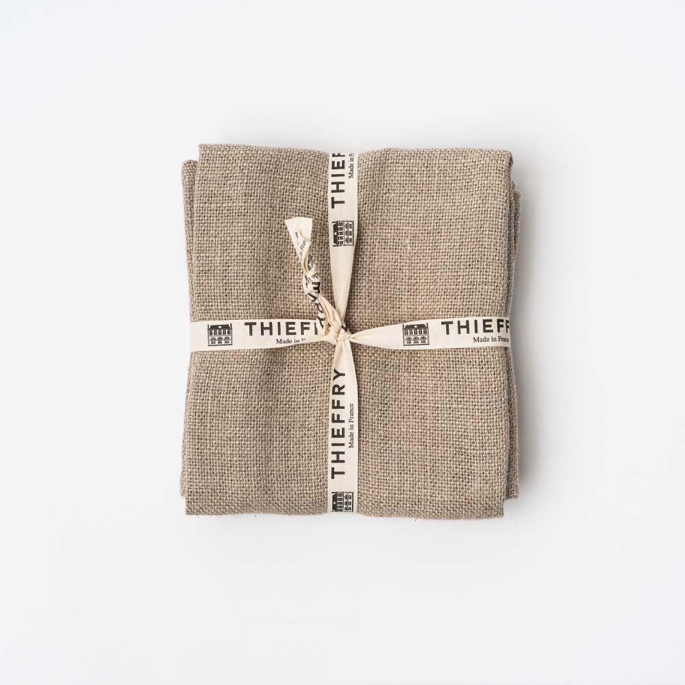 Set of two natural colored Belgian linen Thieffry tea towels tied with a bow on a white background