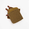 Mustard colored crocheted pot holders in fall colors with leather loops stacked an a white background
