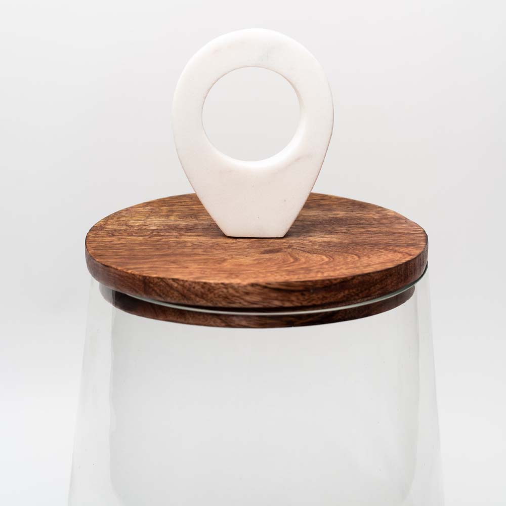 Glass jar with mango wood & marble lid closeup on a white background
