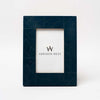 Indigo blue picture frame with geometric inlay pattern on a white background