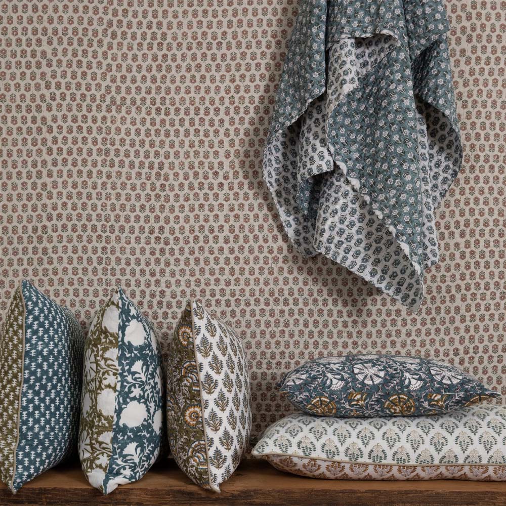Filling spaces brand 'Iris Newport' print square throw pillow on a bench with other complementary pillows