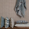 Filling spaces brand 'Iris Newport' print square throw pillow on a bench with other complementary pillows