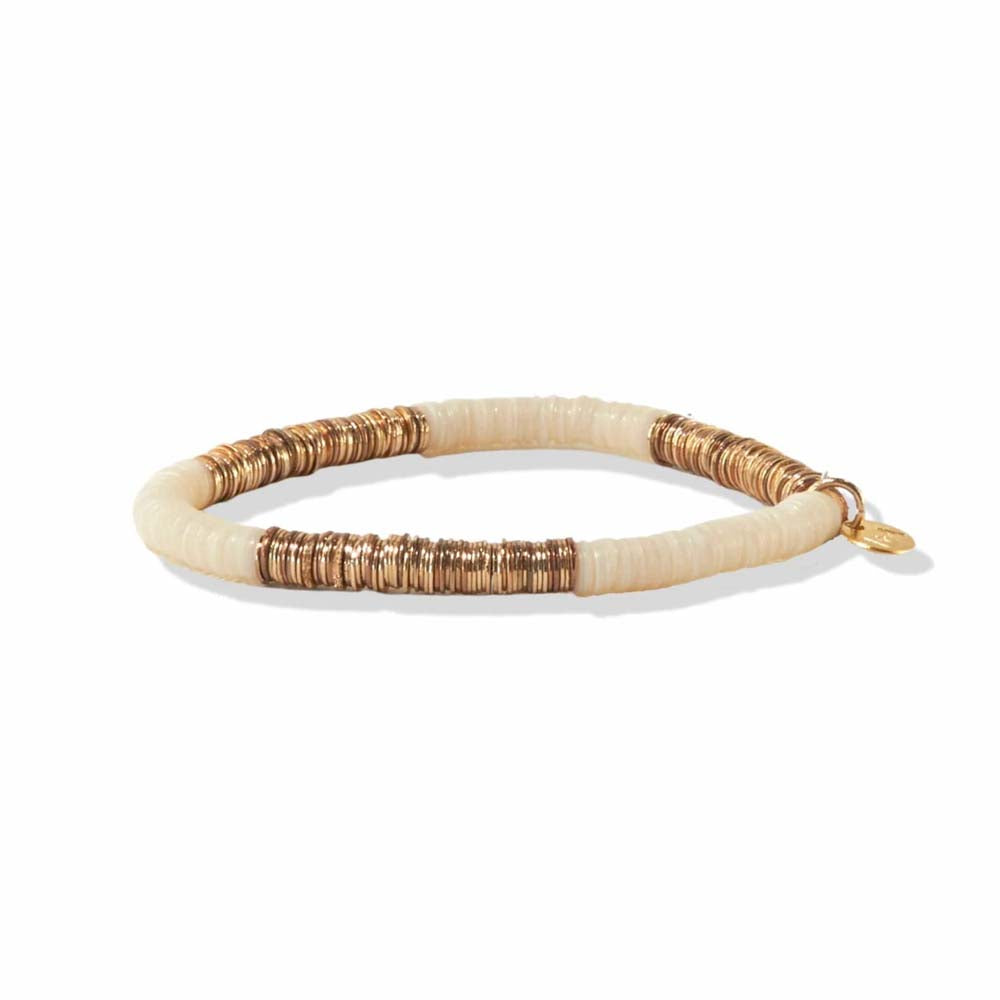 Ink and alloy brand ivory and gold stretch bracelet on a white background