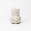 Creative Coop marble vase with round base and ridged straight neck on a white background