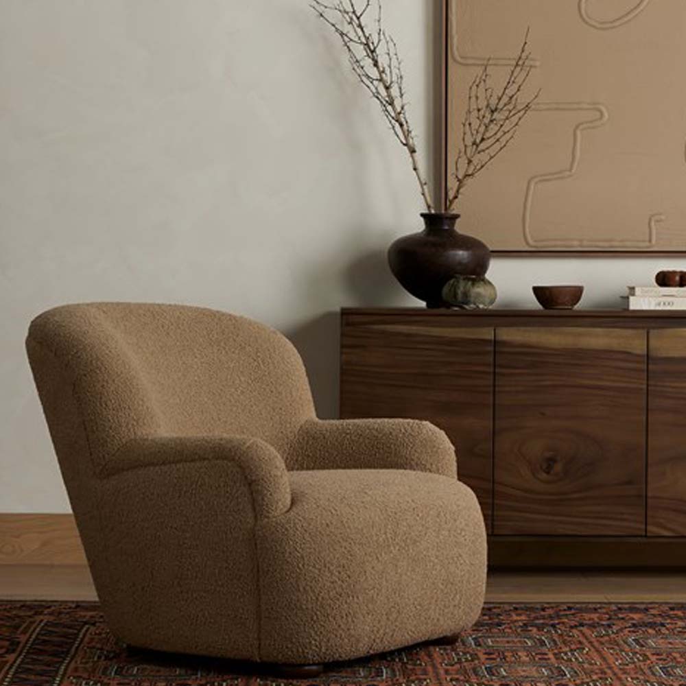 Four Hands Kadon chair in living space with tribal rug and wood sideboard