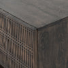 Four hands furniture brand Kelby media console with iron base and four carved doors with square brass pulls on a white background