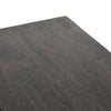 Close up of wood surface on Four hands furniture brand Kelby media console with iron base and four carved doors with square brass pulls on a white background