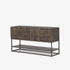 Four hands furniture brand Kelby media console with iron base and four carved doors with square brass pulls on a white background