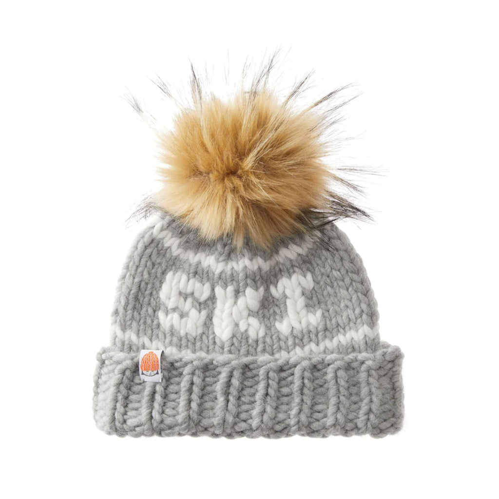 Shit that I knit brand kids beanie with embroidered Ski in heather with faux fur pompom on a white background