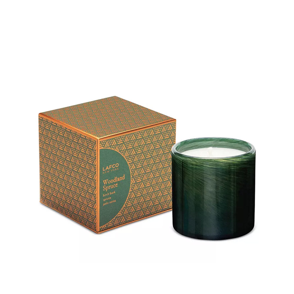 Lafco woodland spruce signaute green glass candle  and box on a white background