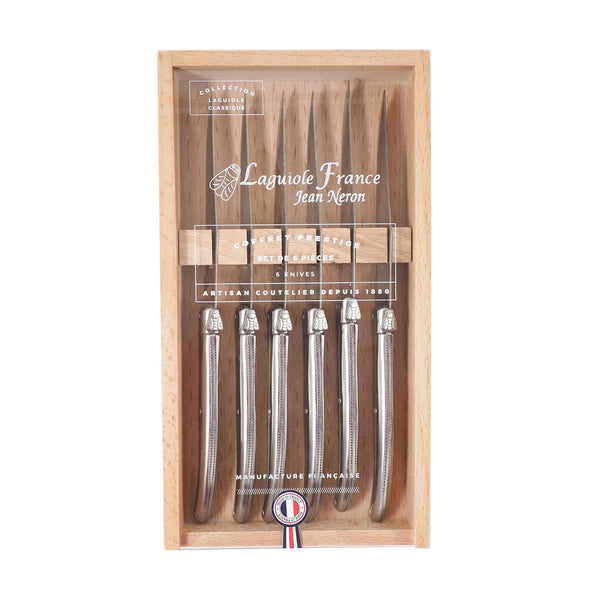 Set of six Laguiole platine made in France stainless steak knives in wood box with acrylic top of a white background