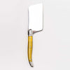 Yellow Laguiole cheese cutter on a white background