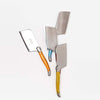 Laguiole rainbow colored cheese cutters on a white background
