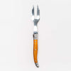 Orange Laguiole cheese fork on a white background