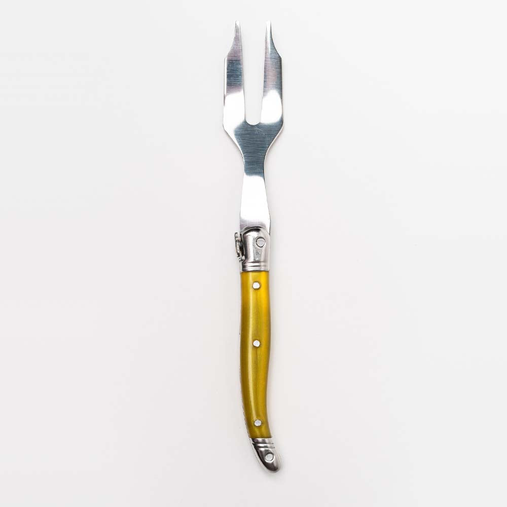 Yellow Laguiole cheese fork on a white background