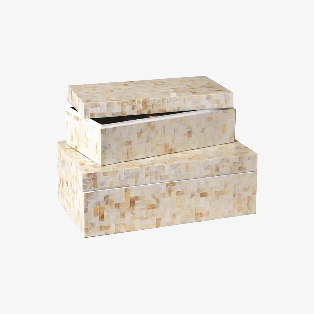 Two decorative boxes with mother of pearl finish stacked on a white background