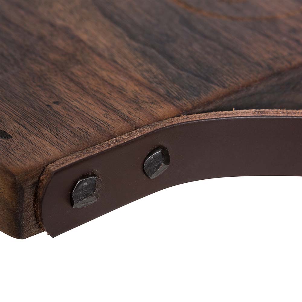 Close up photograph of grommets attaching leather handle to walnut cutting board