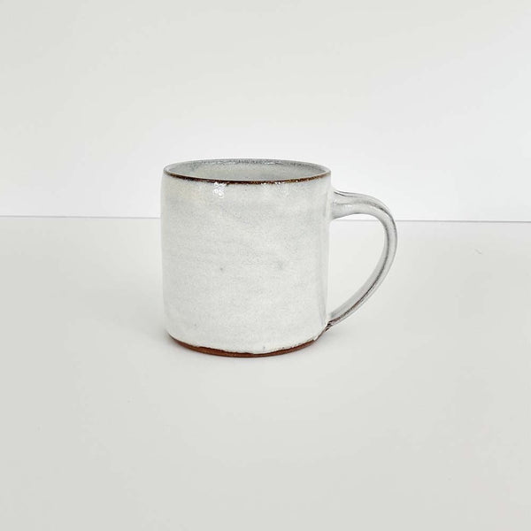 White handmade mug on a white background