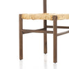 Close up of rush seat on wood 'Largo' dining chair in russet mango by four hands furniture on a white background