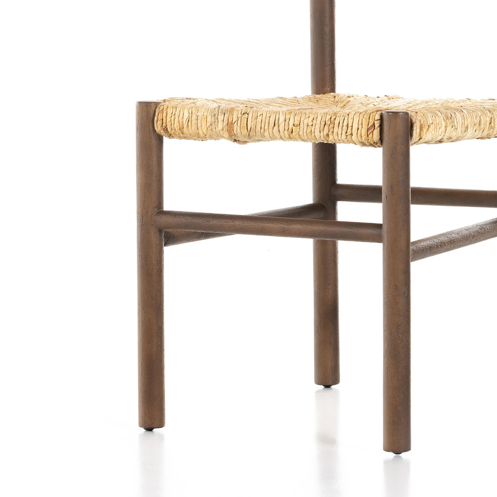 Close up of rush seat on wood 'Largo' dining chair in russet mango by four hands furniture on a white background