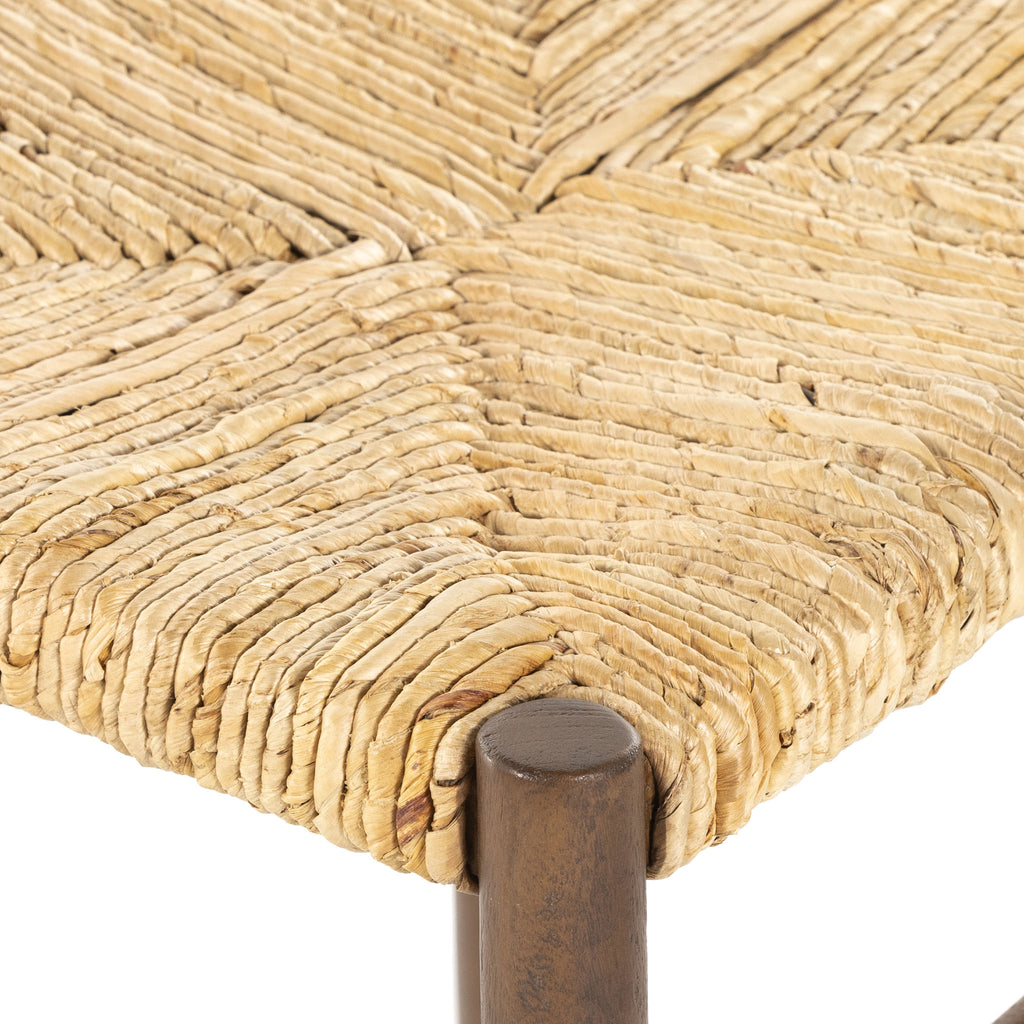 Close up of rush seat on wood 'Largo' dining chair in russet mango by four hands furniture on a white background