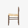 Close up of rush seat on wood 'Largo' dining chair in russet mango by four hands furniture on a white background