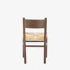 Close up of rush seat on wood 'Largo' dining chair in russet mango by four hands furniture on a white background