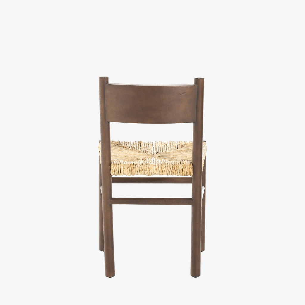 Close up of rush seat on wood 'Largo' dining chair in russet mango by four hands furniture on a white background