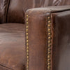 Close up of nailheads on Four hands brand brown leather Larkin sofa