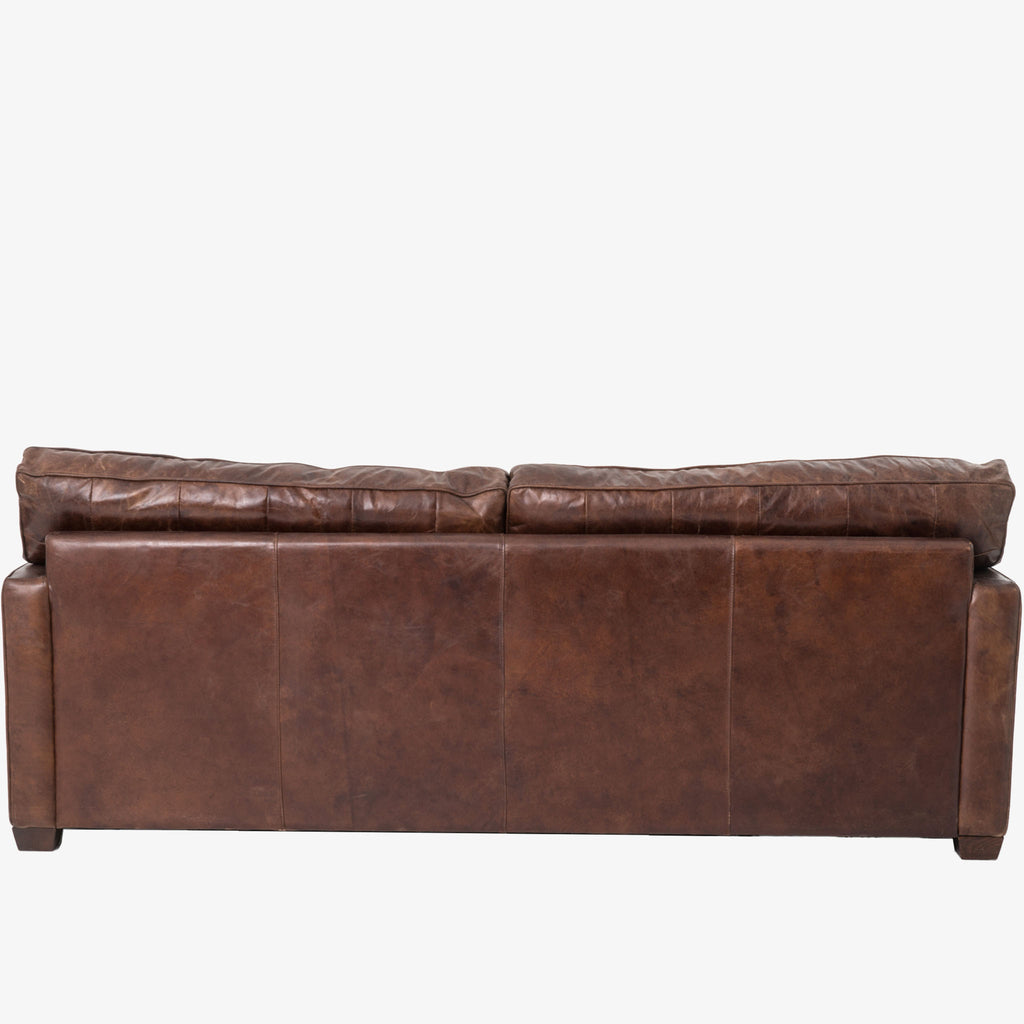 Back view of Four hands brand brown leather Larkin 88 inch sofa on a white background