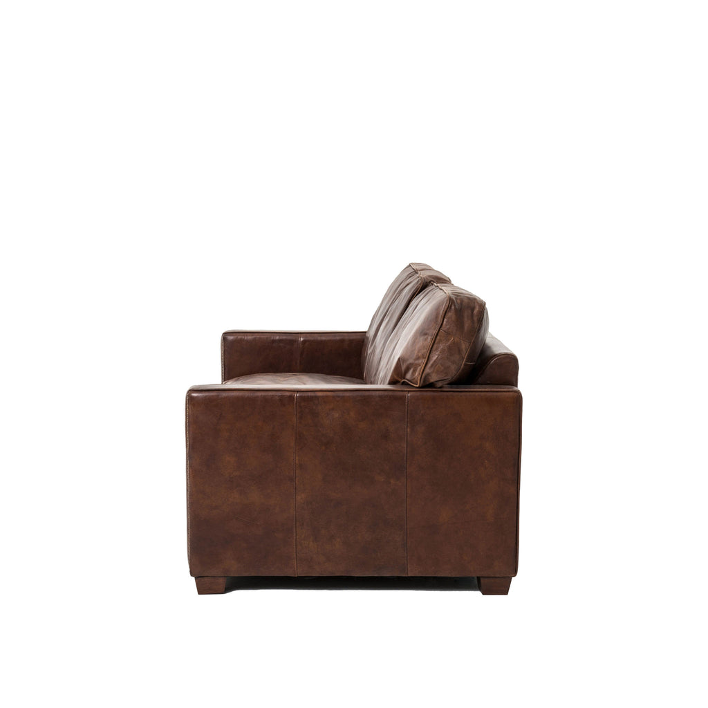 Side view of Four hands brand brown leather Larkin sofa on a white background