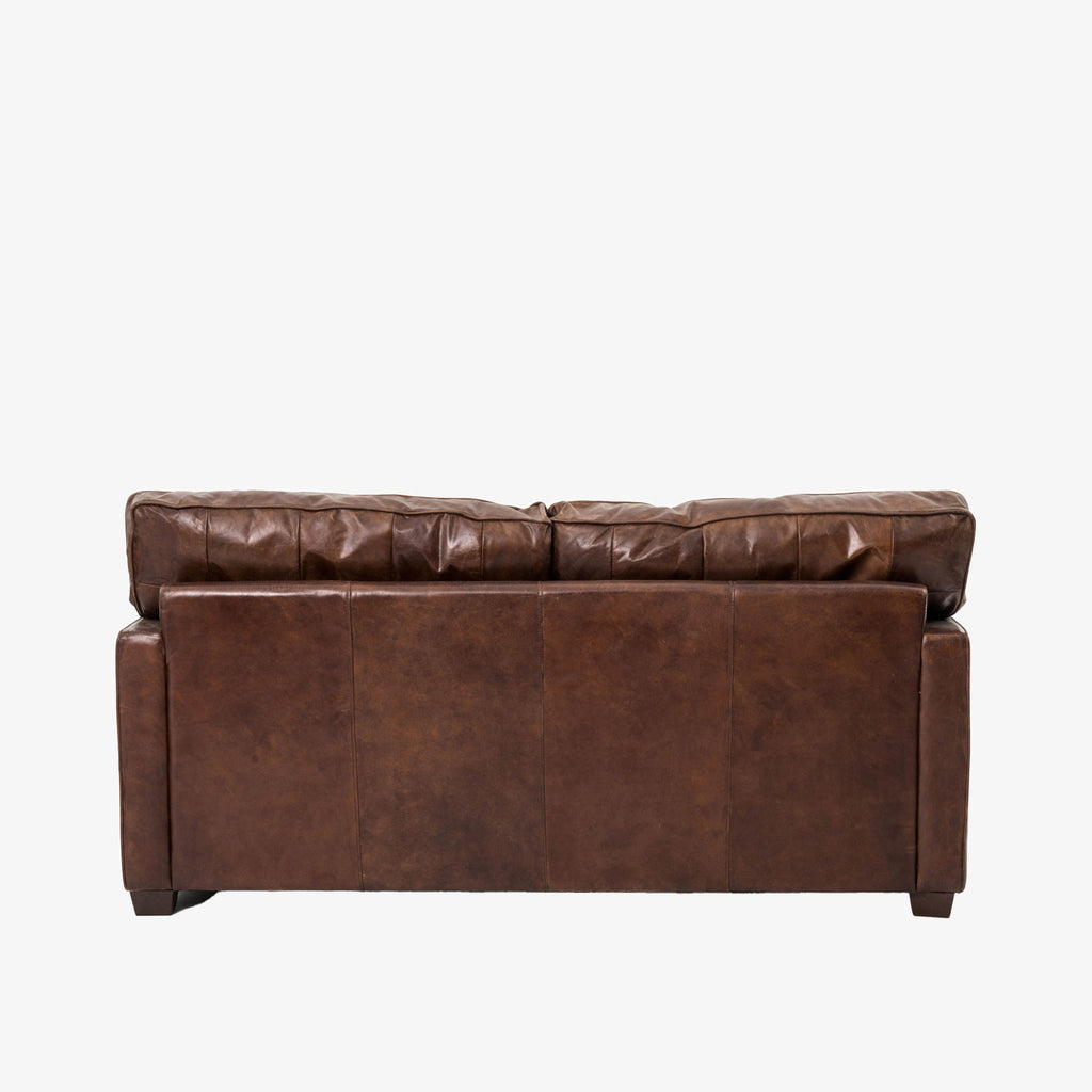 Back view of Four hands brand brown leather Larkin 72 inch sofa on a white background