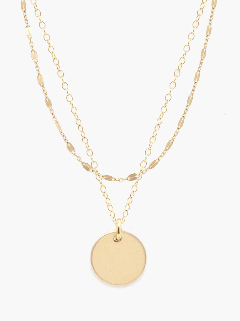 Able jewelry gold layered necklace with two chains and circle pendant on white background