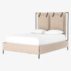 Upholstered 'Leigh' bed by Four hands furniture with metal frame and buckled head board panels on a white background