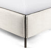 Upholstered 'Leigh' bed by Four hands furniture with metal frame and buckled head board panels on a white background