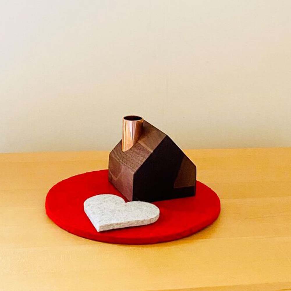 Maple wood cottage candle holder paired with a 7" round red felt pad and small white heart made from upcycled wool.