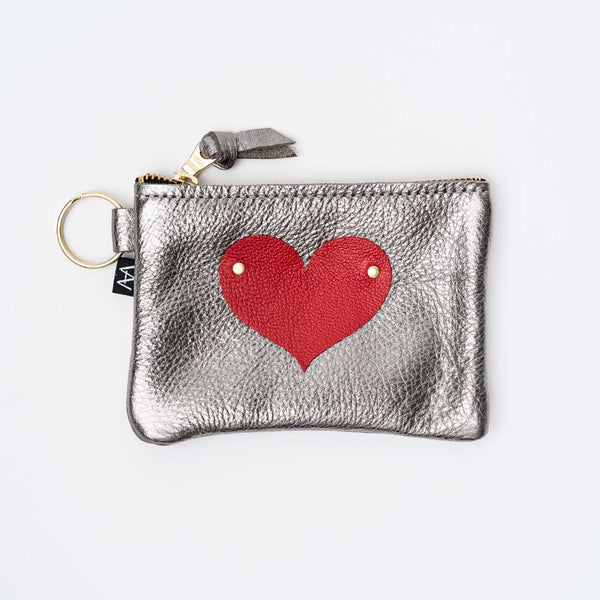 Small zippered silver leather pouch with red heart appliqué