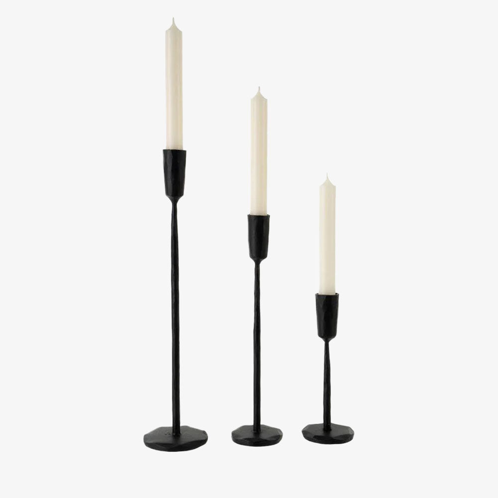 Set of three Indaba brand black luna forged iron candlesticks on a white background