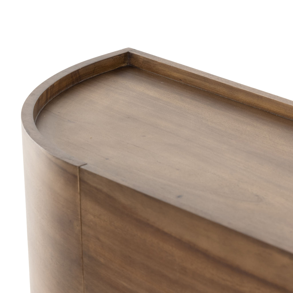 Close up detail of Curved wood 'Lunas' sideboard with small steel feet  by four hands furniture on a white background