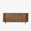 Curved wood 'Lunas' sideboard with small steel feet  by four hands furniture on a white background